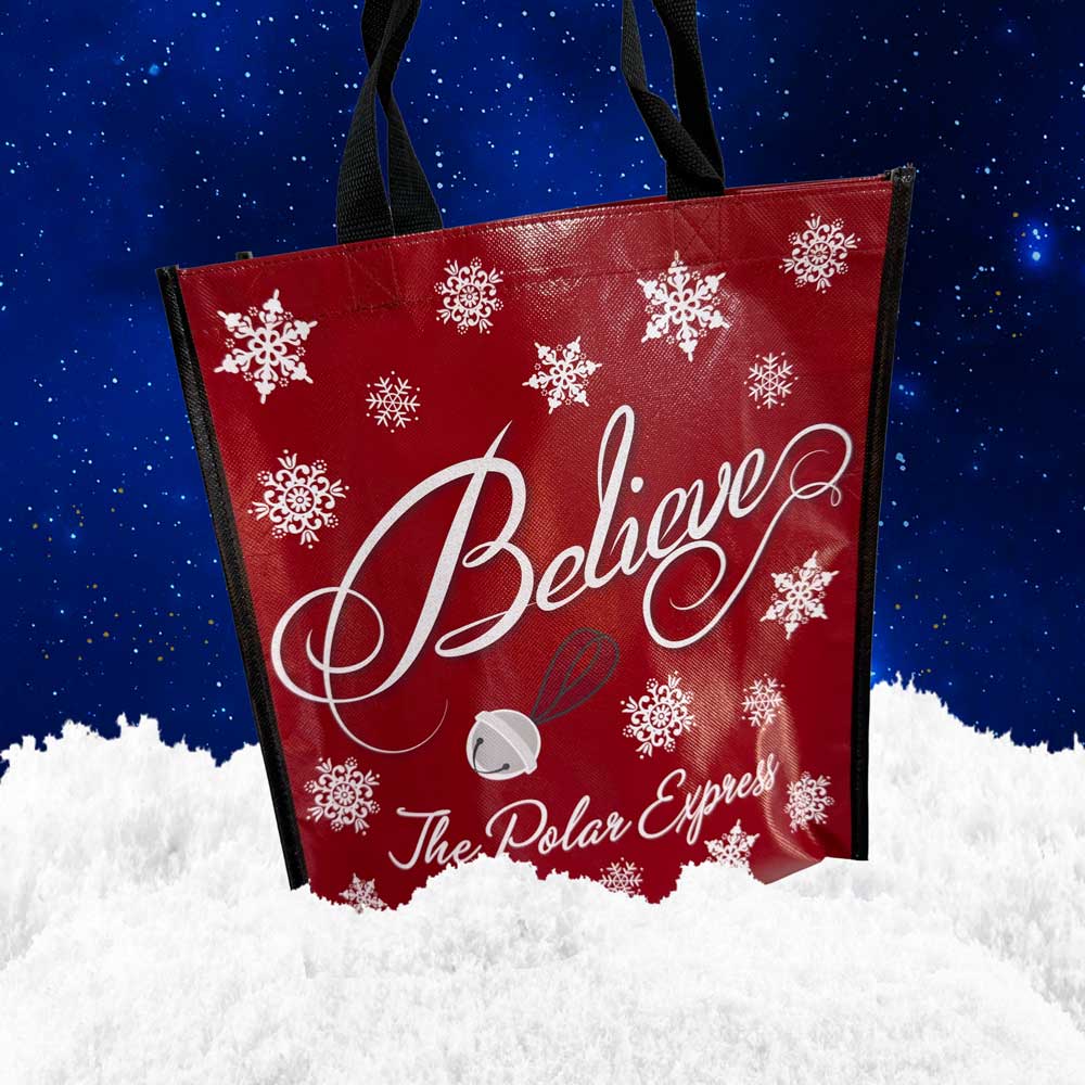 The Polar Express Believe red tote bag with snowflakes and sleigh bell design.
